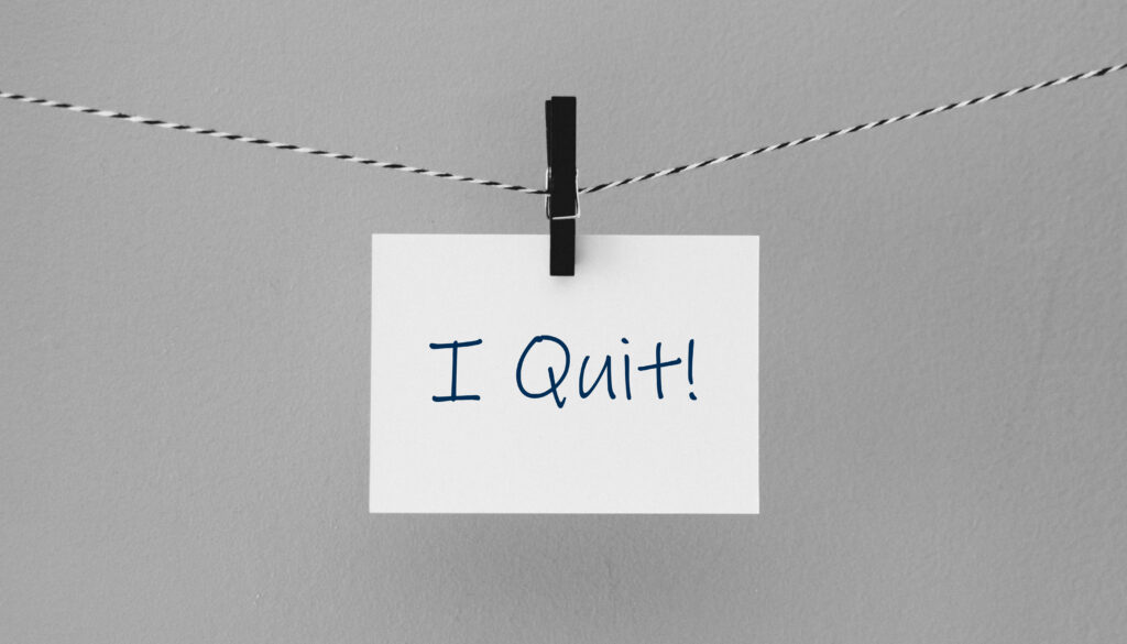 A sign clipped to a string saying "I Quit!"