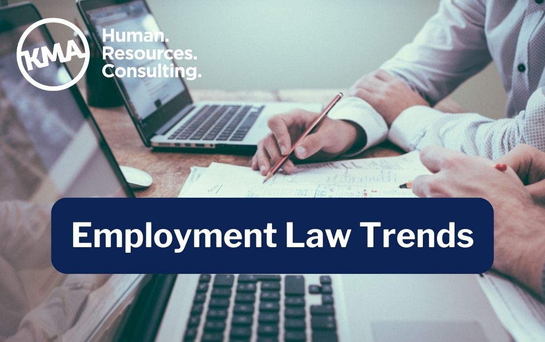 Image of hands working on a document with the title "Employment Law Trends"