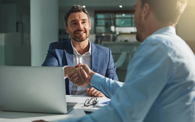 Image of two men shaking hands
